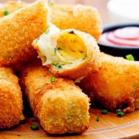 Mozzarella Sticks · Crispy golden creamy Mozzarella sticks served with a savory marinara dipping sauce.