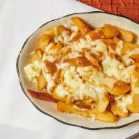 Disco Fries · Crispy golden fries smothered in creamy Mozzarella cheese and savory gravy.