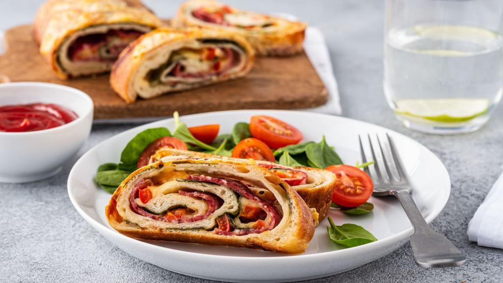 Spinach Pizza Roll · Delicious pizza roll stuffed with fresh spinach and creamy mozzarella cheese. Served with marinara sauce.