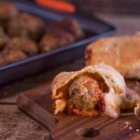 Meatball Pizza Roll · Delicious Italian pizza roll stuffed with ground meatballs and homemade tomato sauce. Served...