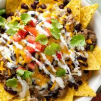 Nachos With Steak / Bistek · MADE WITH FRIED BEANS, YELLOW CHEESE, TOMATO, ONION, CILANTRO, CREAM, JALAPENO AND GUACAMOLE...