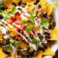 Nachos With Chicken  / Pollo  · MADE WITH FRIED BEANS, YELLOW CHEESE, TOMATO, ONION, CILANTRO, CREAM, JALAPENO AND GUACAMOLE...