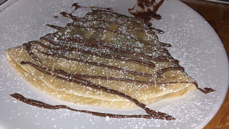 Nutella Crepe · Nutella spread strawberries and bananas.