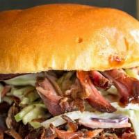 Pulled Pork Sandwich · Slow cooked heritage pork shoulder, smoked over hickory and apple wood, chopped and served o...