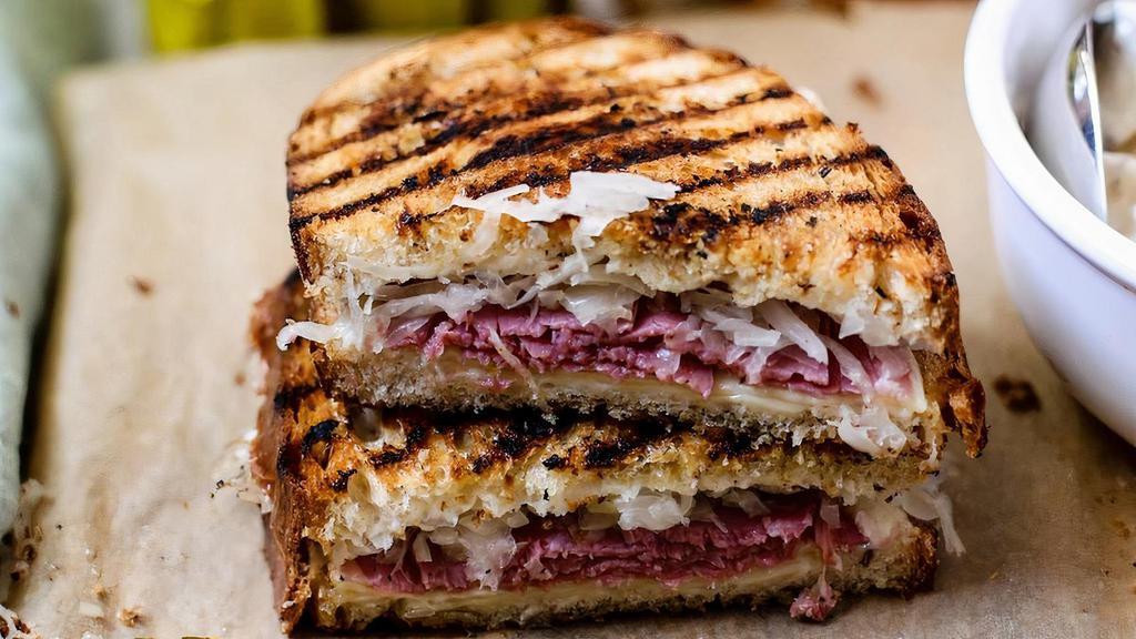 House-Made Pastrami Reuben · A classic: house-made pastrami, sauerkraut, Swiss, & Russian dressing on griddled rye bread.
