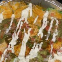 Awsome Nachos · Homemade tortilla chips, served with pico de gallo, black beans, sour cream, guacamole and j...