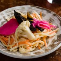 Pickle Slaw · Crunchy, sweet n’ tangy pickled carrots, papaya, and daikon + fresh shaved cabbage. Half pou...