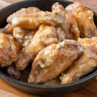 Garlic Parmesan Bone-In Wings · Served with celery or carrots, and blue cheese or ranch.