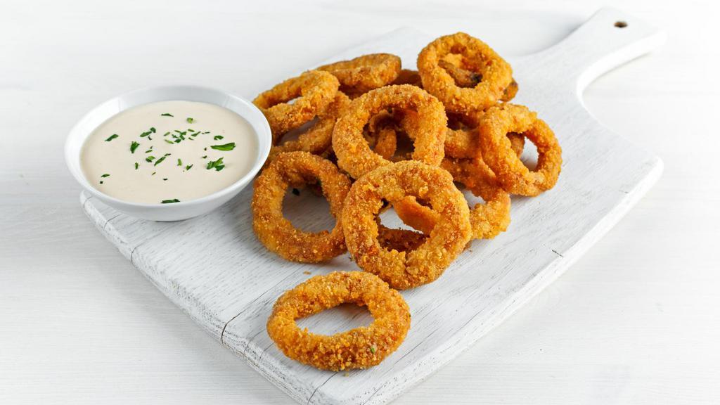 Onion Rings · Thick-cut onion rings are made from whole white onions, battered with a subtle blend of spices.