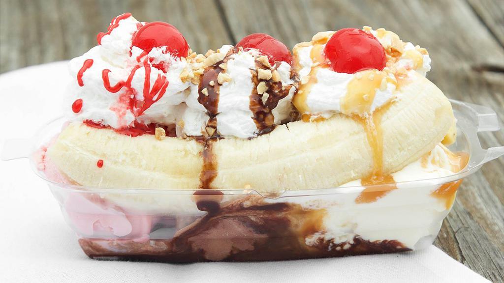 Banana Split · Vanilla, Chocolate, Strawberry Ice Cream with Chocolate, Strawberry &  Caramel Syrups, Peanuts,  Whipped Cream & Cherries