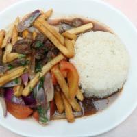 Lomo Saltado · Sauteed sirloin strips with onions, tomatoes, and fries. Served with your choice of side.