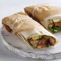 The Grilled Chicken Shawarma · Delicious wrap made with grilled, seasoned chicken, sliced tomatoes and pickles, served in a...
