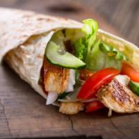 The Chicken Tender Wrap · Delicious wrap made with seasoned chicken tenders, shredded lettuce, sliced tomatoes, onions...