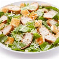 The Chicken Caesar Salad · Large bowl of fresh salad made with seasoned chicken, shredded romaine lettuce and parmesan ...