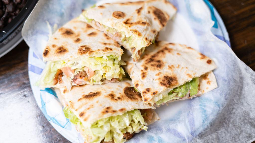Regular Chicken Quesadilla · Made with Monterey jack cheese melted between two fresh flour tortillas. Served with lettuce, tomato, and cheese.