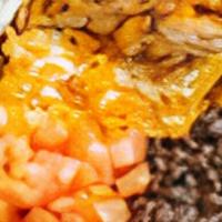 Nachos With Grilled Chicken · White corn tortilla chips covered with melted cheese, jalapeños, black beans, tomatoes, and ...