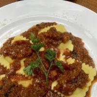Ravioli · Ravioli filled with cheesy goodness,
breaded & deep-fried until the pasta shell becomes slig...