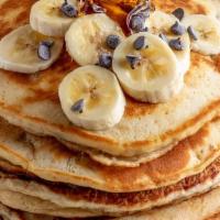 Banana Pancakes · Buttermilk pancakes filled with diced bananas and lightly dusted with powdered sugar. Served...
