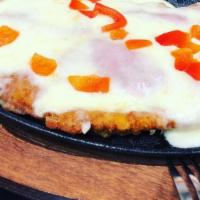 Pechuga De Pollo A La Uruguaya · Breaded chicken breast with ham and melted Mozzarella cheese . Served with choice of two sid...