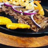 Churrasco Con Camarones A La Parrilla · Twelve oz grilled skirts steak with shrimps served with two sides.