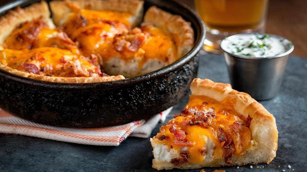 Pizza Skins · UNO’s signature deep dish pizza crust stuffed with mashed red bliss potatoes and topped with bacon and cheddar. Sour cream on the side.
