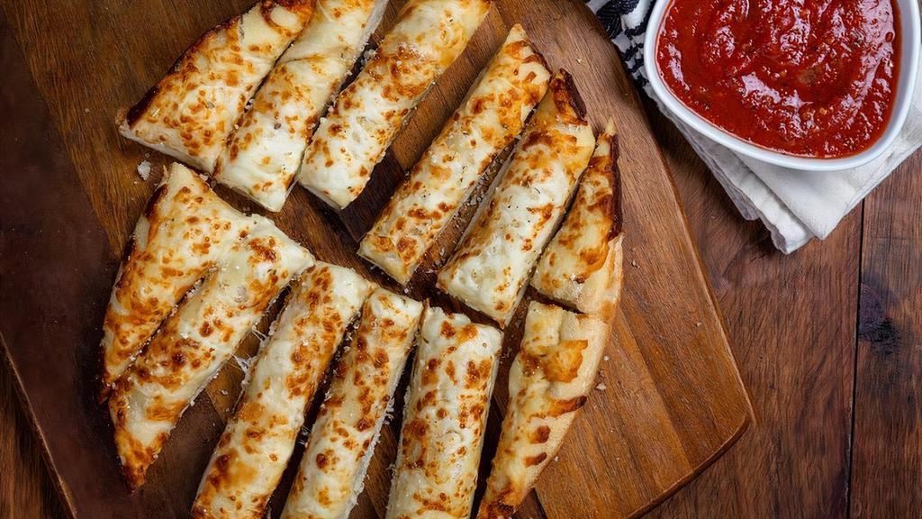 Cheesy Garlic Bread · Pizza dough topped with garlic and our three-cheese blend, baked and served with housemade marinara.