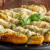 Cheesy Pesto Garlic Bread  · Pizza dough topped with basil pesto, garlic, and our three-cheese blend, baked and served wi...