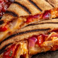Buffalo Chicken Quesadilla · Grilled pizza crust filled with cheddar, mozzarella, seasoned tomatoes, and red onions. Serv...