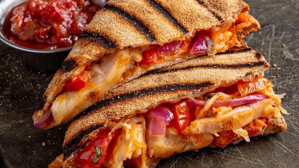 Buffalo Chicken Quesadilla · Grilled pizza crust filled with cheddar, mozzarella, seasoned tomatoes, and red onions. Served with salsa and sour cream.