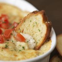 Shrimp & Crab Dip · A creamy shrimp, crab, and parmesan dip baked and topped with diced fresh tomatoes. Served w...