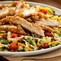 Honey Crisp Chicken Salad · Fresh greens, chicken tenders, thin spaghetti, bacon, red peppers, tomatoes, cheddar, and ho...