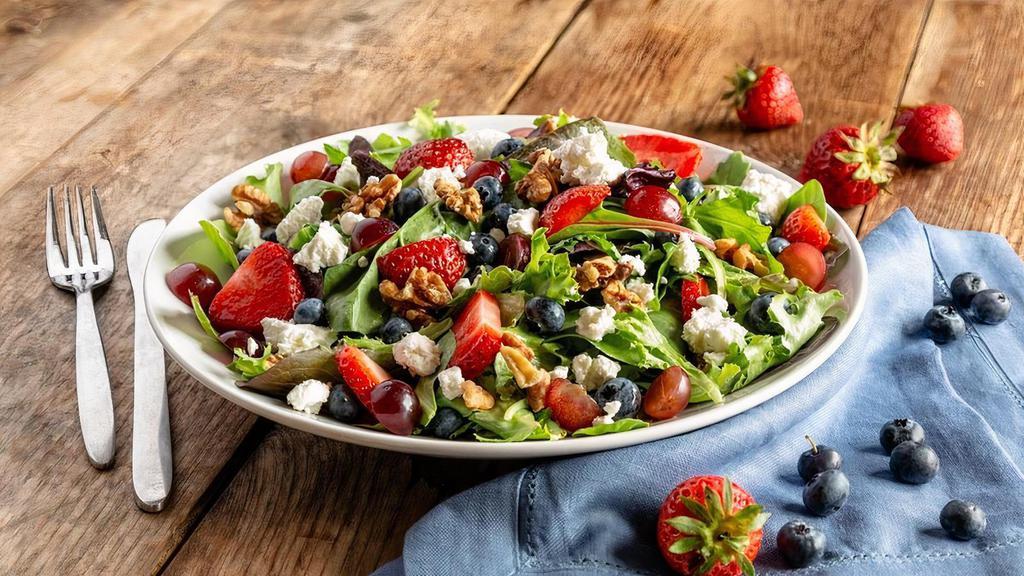 Berry & Goat Cheese Salad · Spring mix with fresh strawberries, grapes, blueberries, and walnuts, tossed with low-fat honey vinaigrette and topped with goat cheese.