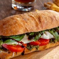 Caprese Sandwich · Slices of fresh mozzarella and tomatoes with basil pesto on a ciabatta roll baked just until...