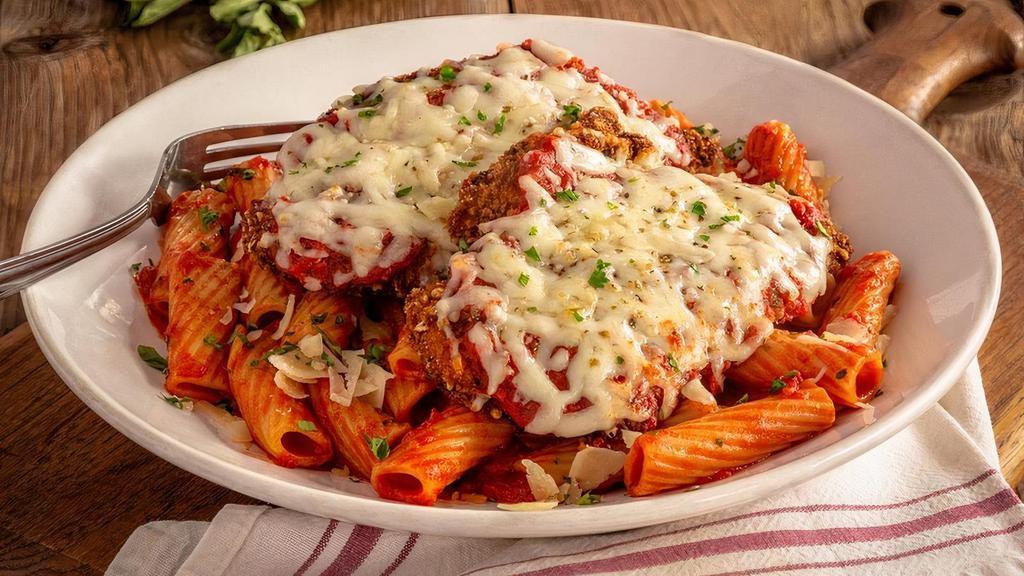 Romano-Crusted Chicken Parmesan · Chicken breasts, hand-breaded with panko bread crumbs and romano, topped with melted mozzarella, served over rigatoni tossed in our housemade marinara.