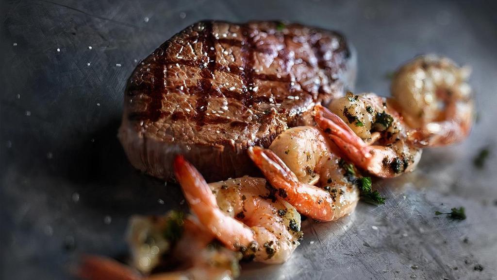 Grilled Shrimp & Sirloin · A 10oz. USDA choice top sirloin and a skewer of shrimp basted in a basil and garlic marinade.