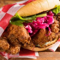 Hot Fried Chicken Sandwich · Crispy chicken thigh, bread and butter pickles, charred chive ranch, spicy slaw.