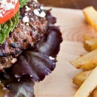 Greek Burger · Mouthwatering Beef Burger served in a pita bread and topped with lettuce, onion, tomato, and...