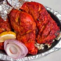 Tandoori Chicken (Full) · Chicken marinated in yogurt, Indian masala, and dry herbs.