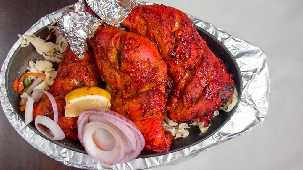 Tandoori Chicken (Full) · Chicken marinated in yogurt, Indian masala, and dry herbs.