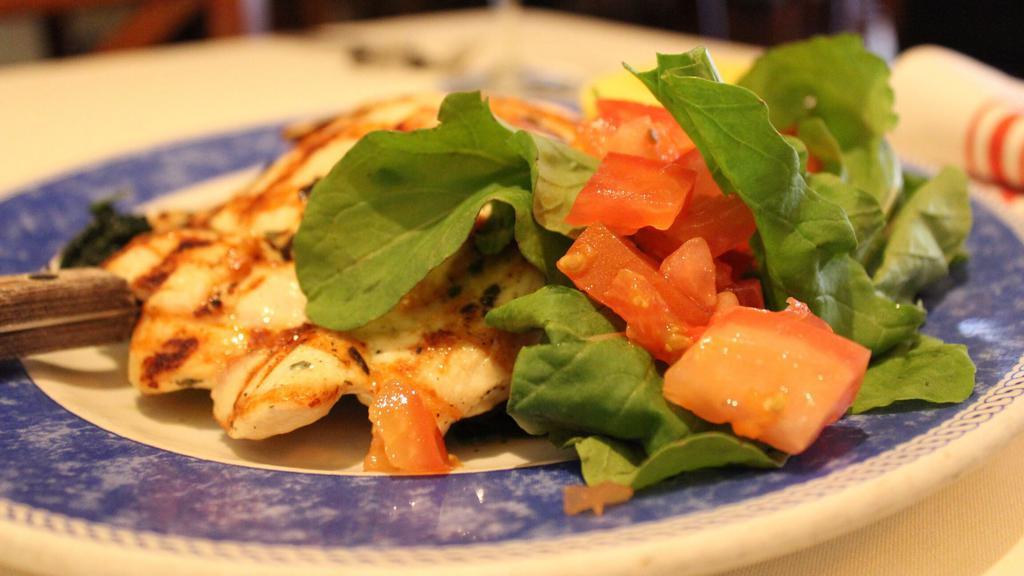 Petto Di Pollo Paillard · Grilled brest of chicken paillard, served with spinach and carrot.