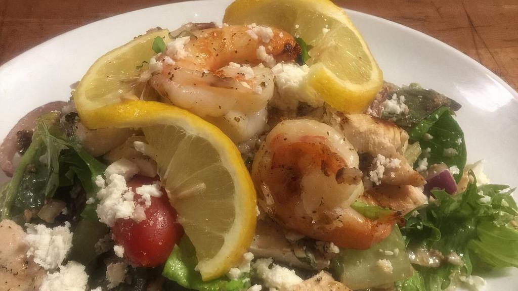 Mama Bella'S Salad · Lettuce, tomato, cucumbers, olives, onions, carrots, grated cheese romano cheese, feta cheese, grilled chicken and grilled shrimp with lemon, extra virgin olive oil and a splash of balsamic vinaigrette.