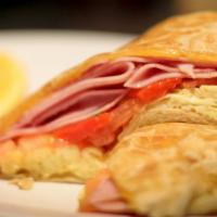 The Omelette · Scrambled eggs, ham, roasted red peppers. Tomatoes & melted Cheddar cheese.