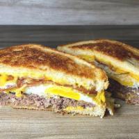 Bacon Cheesy Egg Burger · Bacon, 2 fried eggs, cheese and burger inside a grilled thick sourdough bread