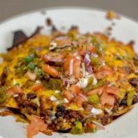 Nachos · corn tortilla chips topped with beef chili, shredded cheese,diced tomatoes and onions, jalap...