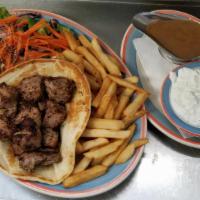 Classic Pork Souvlaki · Chuncks of grilled marinated pork served on pita with greek salad and fries