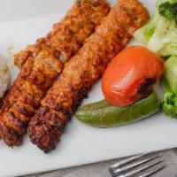 Adana Kebab Chicken · Finely chopped chicken, seasoned with peppers and parsley, grilled on a skewer and served wi...