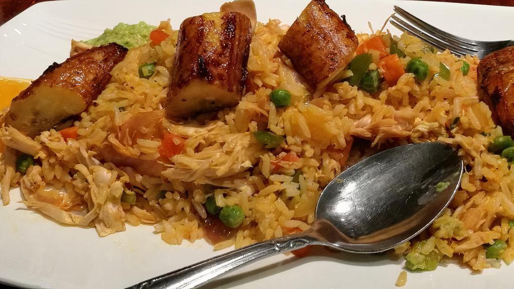 Arroz Con Pollo · Rice with chicken and vegetables.
