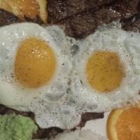 Churrasco Con Carne Asada · Sabor Andino favorite: Grilled beef topped with fried eggs and served with rice, fried and a...
