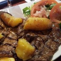 Palomilla Asada · Grilled beef served with rice, beans, plantains and salad.