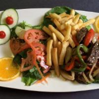 Lomito Salteado · Beef sauteed with peppers and onions served with rice and French fries.